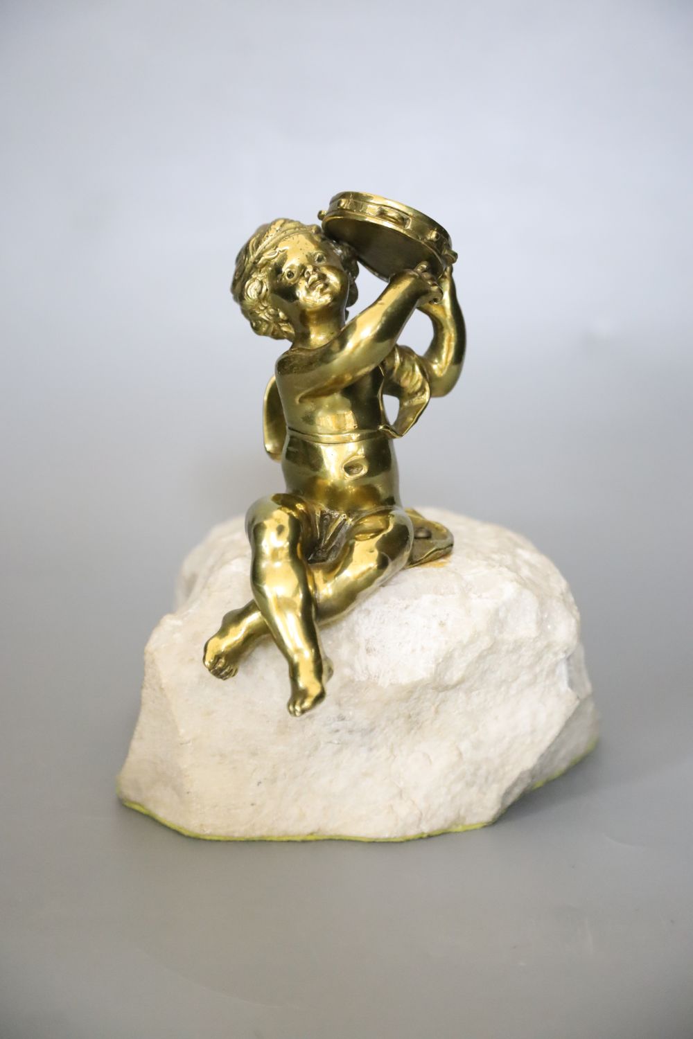 An ormolu seated tambourinist, on granite plinth, 19cm